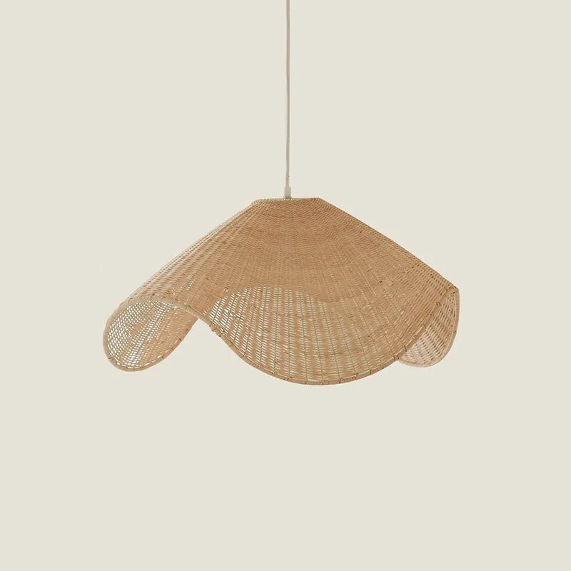 Handmade woven rattan and willow chandelier with warm LED light in a rustic setting.