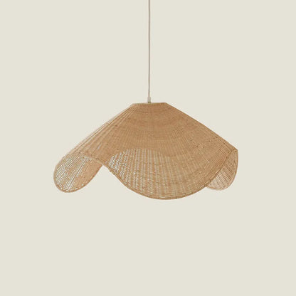 Handmade woven rattan and willow chandelier with warm LED light in a rustic setting.