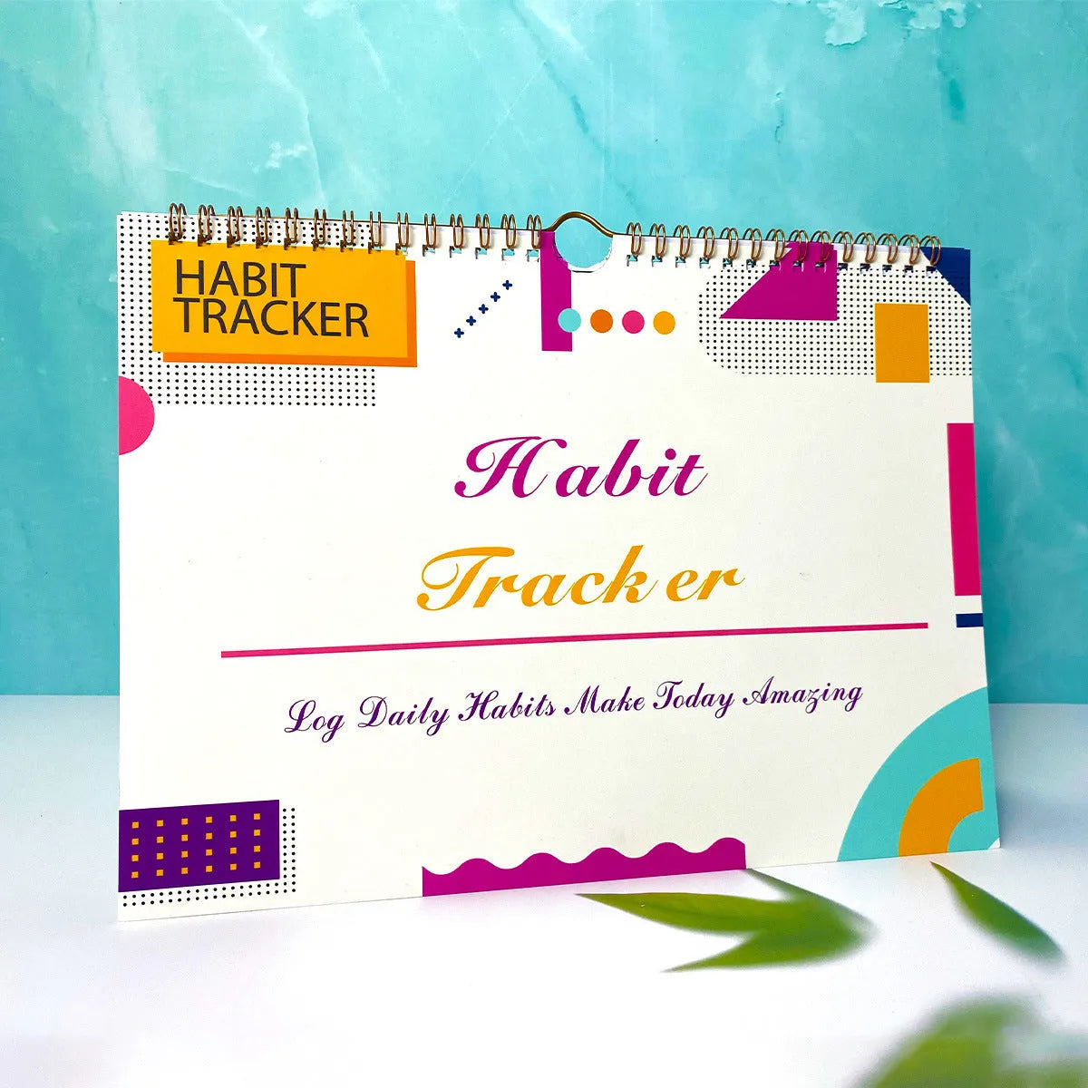 Habit tracking planner book open showing 12 internal pages, measuring 21cm by 28cm.