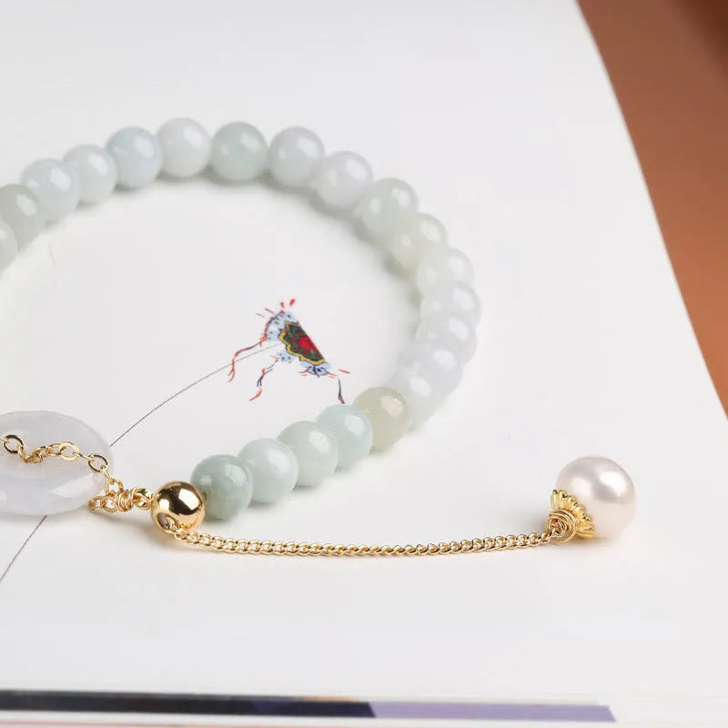 Natural jade bracelet with a geometric peace buckle clasp and round pendant.