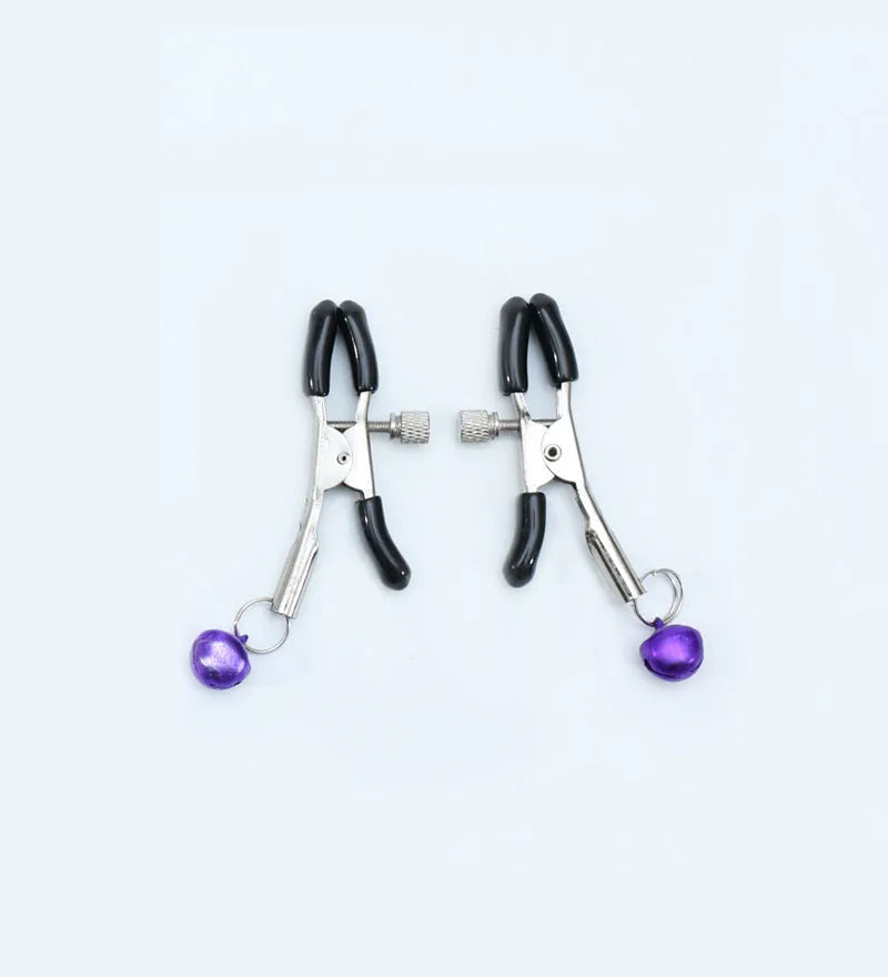 Red and purple nipple clamps with small bells and feather decorations for adult sensory play.