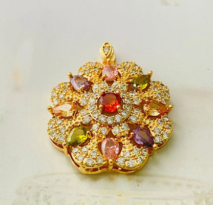Close-up of a women's flower-shaped pendant necklace with a colourful zircon stone in a choice of gold, champagne gold, or platinum colour finishes.