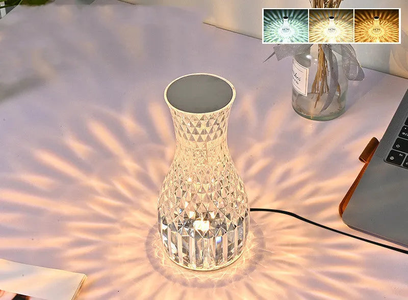 Vase-shaped crystal table lamp with remote control on a bedside table, showing diamond-like glow and USB charging port.