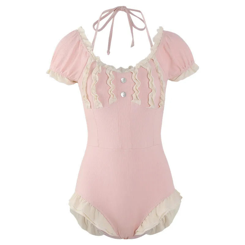 Pink women's conservative one-piece swimsuit with Siamese design on a hanger