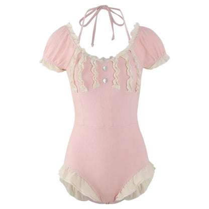 Pink women's conservative one-piece swimsuit with Siamese design on a hanger
