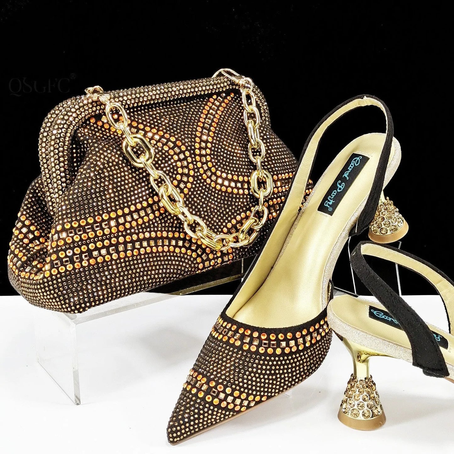 Women's pointed toe high heels with rhinestones and a matching small bag in blue.