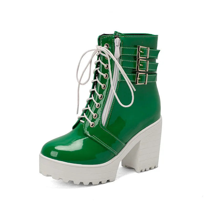 Women's black chunky heel ankle boots with round toe and front lace-up on a wooden floor.