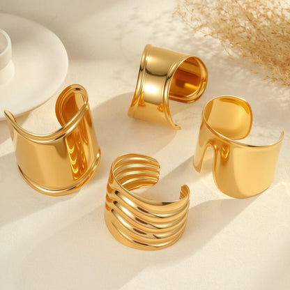 Women's stainless steel bracelet with 18K gold plating featuring exaggerated wide geometric wave design and niche opening