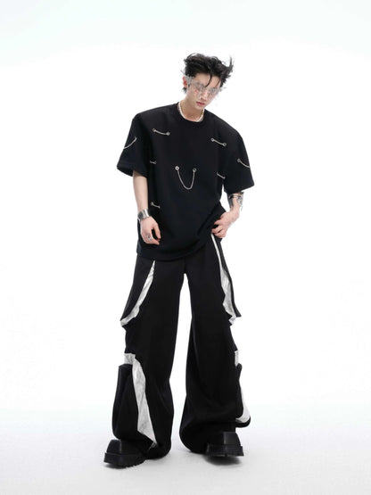 Black men's t-shirt with metal chain and padded shoulder detail on a short sleeve cotton-polyester blend.