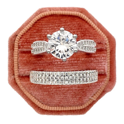 White gold-coloured geometric wedding ring with round elements on a finger