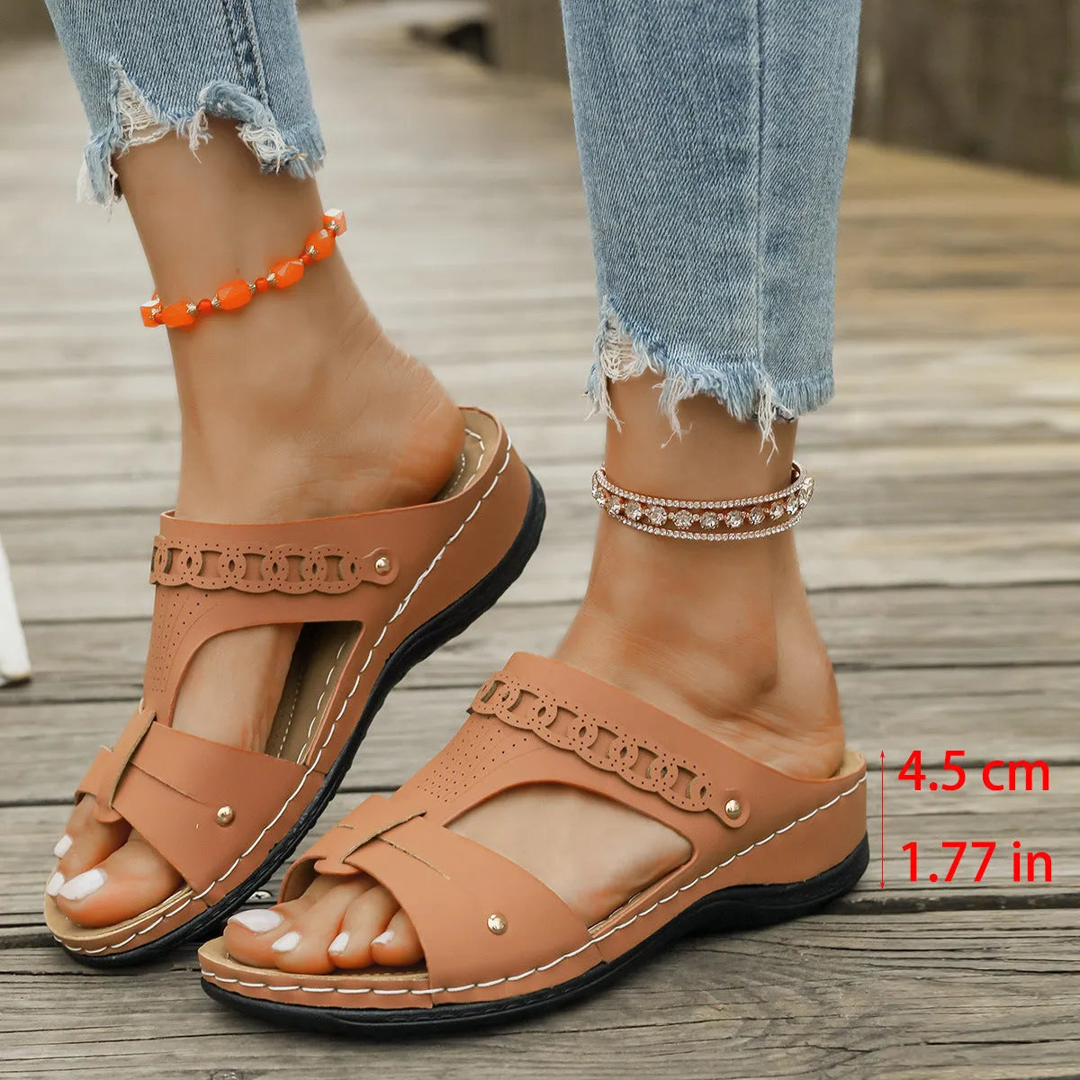 Beige Roman style slippers with a fish mouth toe, slope heel, and rubber sole.