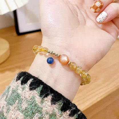Gold rutilated quartz sunstone crystal bracelet with diamond shape and round elements for women