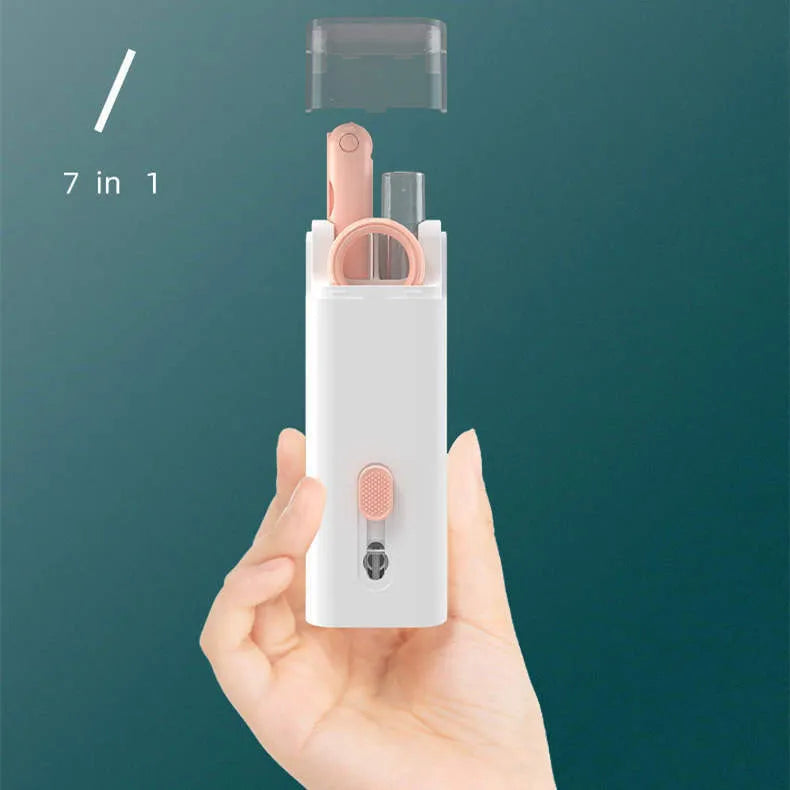 White electronics cleaning kit with a cleaning pen, spray bottle, brush, and keycap puller on a table