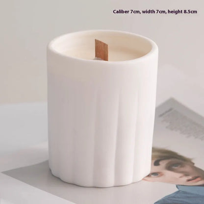 Set of ten round white ceramic candlesticks with minimalist relief patterns on a dining table