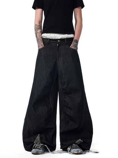 Black wide leg jeans showing loose straight fit and colour-changing embroidered red ear detail.