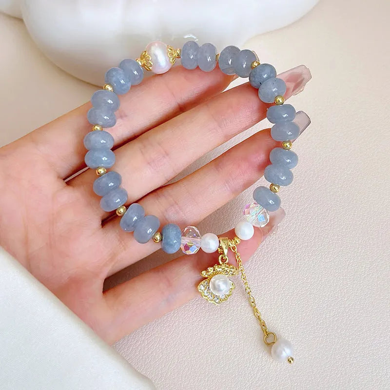 Natural aquamarine pearl bracelet with abalone shell charms on adjustable cord