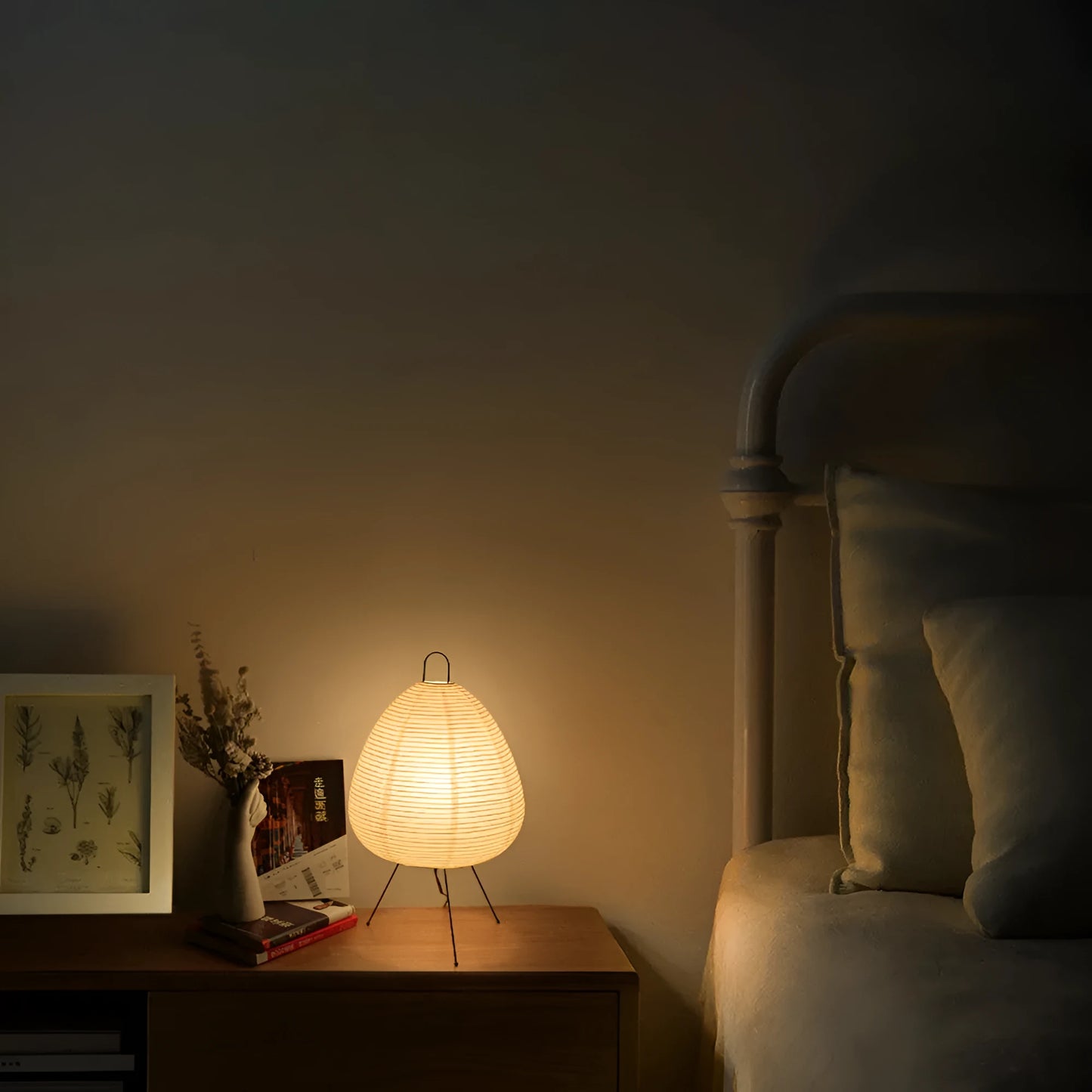 Japanese style table lamp with a white handmade rice paper shade on a slim aluminium base.