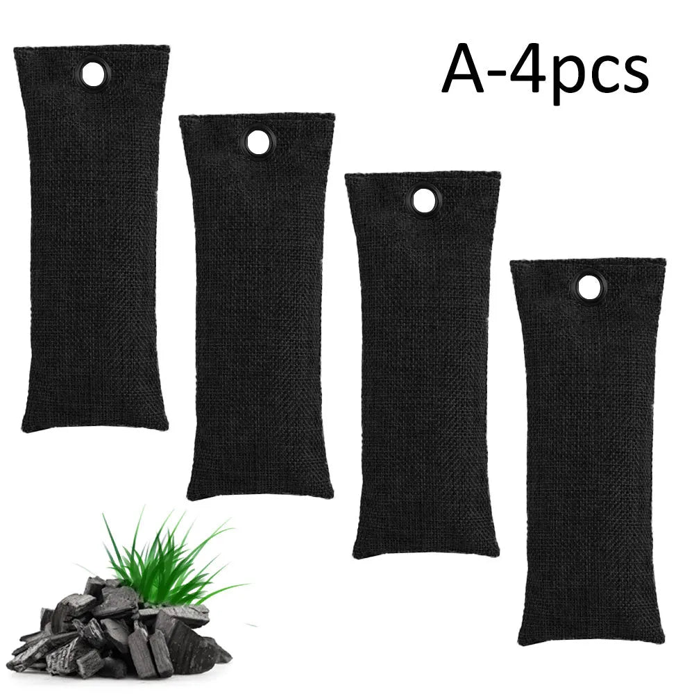 Set of black, green, grey, and blue rectangular bamboo charcoal deodorising bags on a white surface.