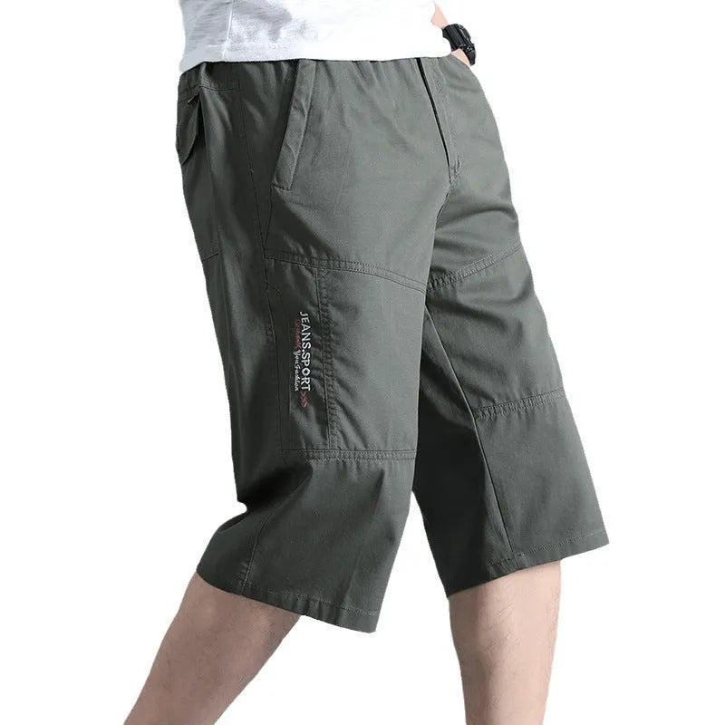 Man wearing loose grey cotton sports pants with a straight leg and cropped length.