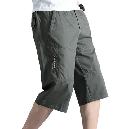 Man wearing loose grey cotton sports pants with a straight leg and cropped length.