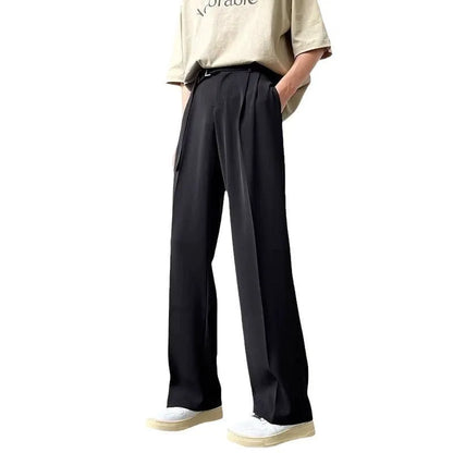 A pair of black straight leg wide fit women's trousers with a loose, casual silhouette on a hanger.