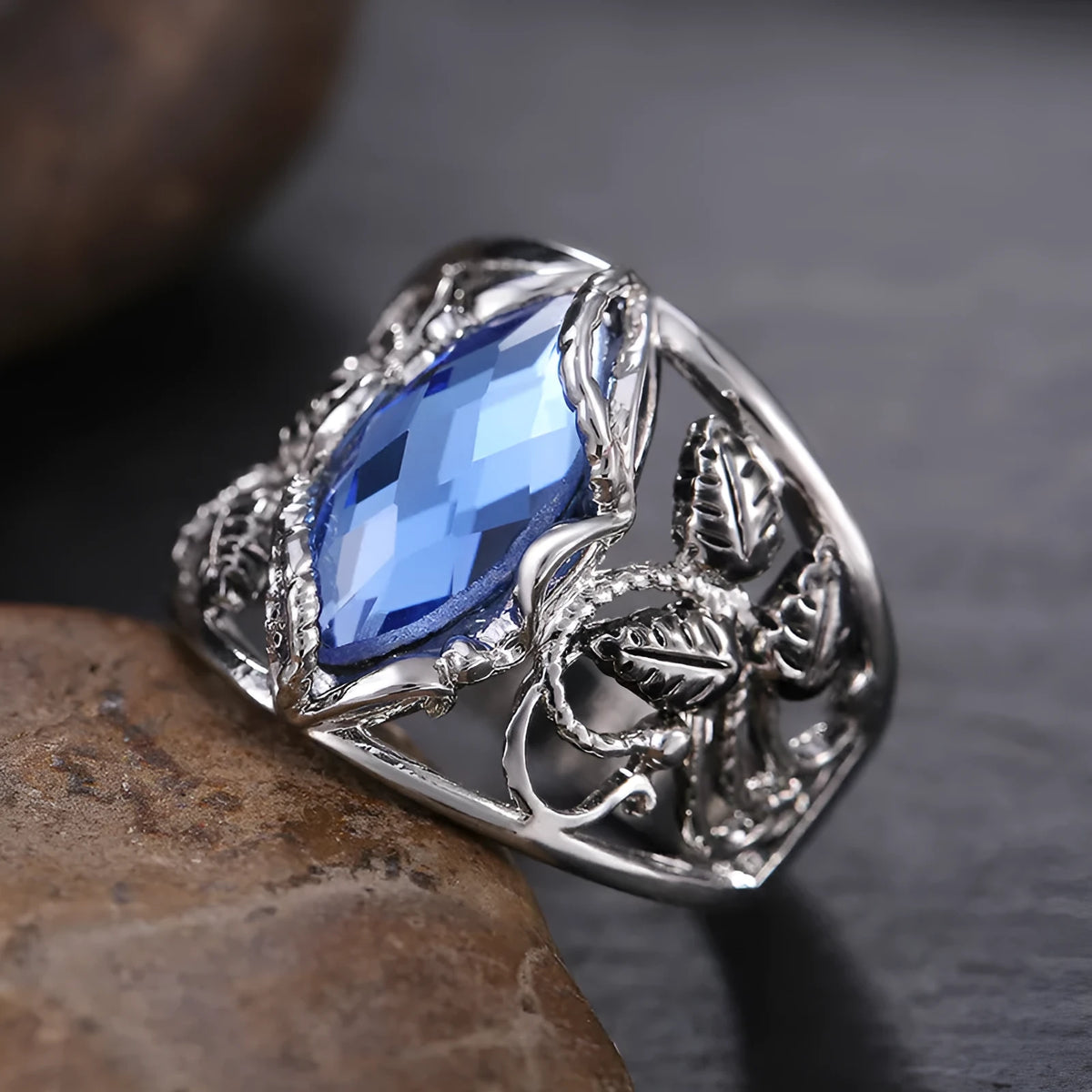Blue horse eye-shaped crystal ring in alloy metal with geometric design on finger