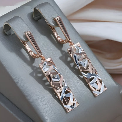 A pair of rectangular hollow stud earrings with a two-tone electroplated finish.