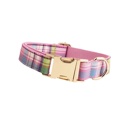 Four-piece dog accessory set showing cloth collar, leash, vest, and bow in coordinated colours
