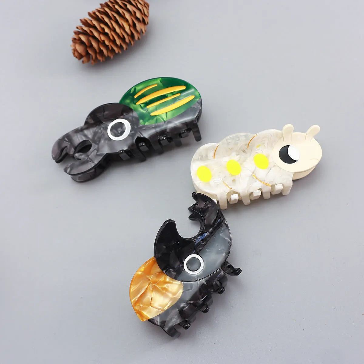 Handmade cellulose acetate beetle grip with caterpillar element in cartoon style decorative clip