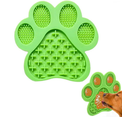 Bone-shaped blue silicone dog licking mat with suction cups on a tile surface