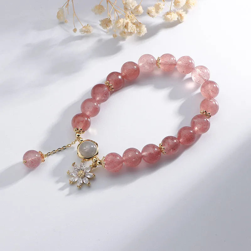 Korean Mori style crystal bracelet with a strawberry quartz bead and floral electroplated metal details