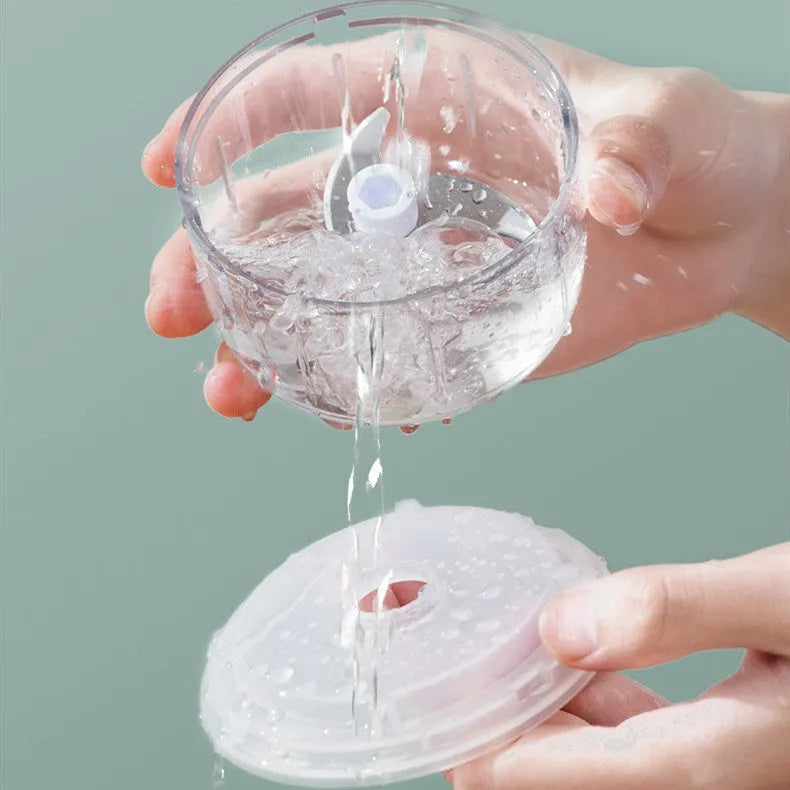 Green portable electric garlic chopper with transparent cup and USB charging cable