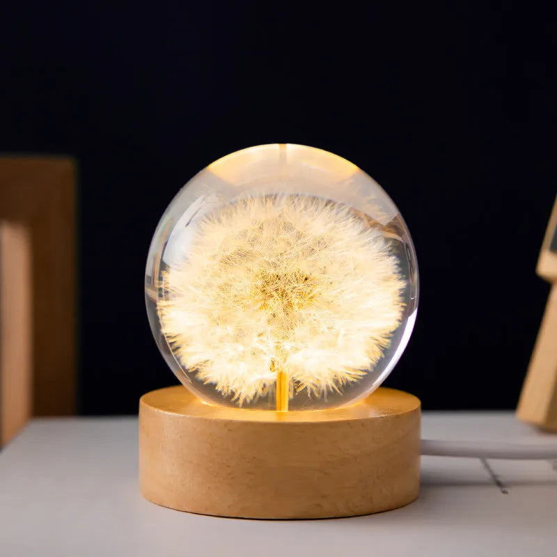 USB-powered 3D dandelion crystal ball night light on a natural beech wood stand.