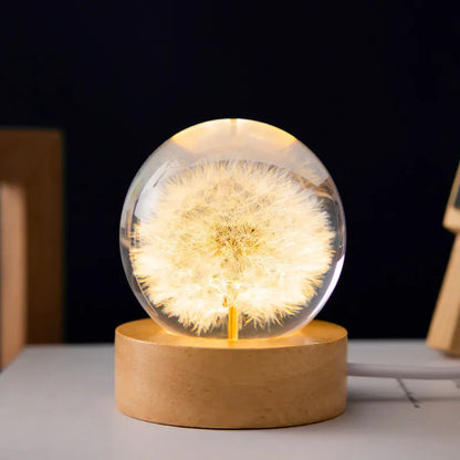 USB-powered 3D dandelion crystal ball night light on a natural beech wood stand.