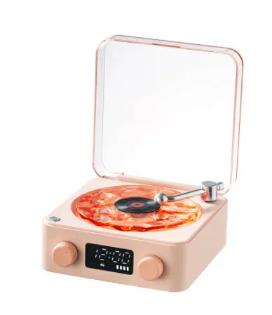 Retro-style turntable Bluetooth speaker with glowing RGB light projection on a wooden surface.