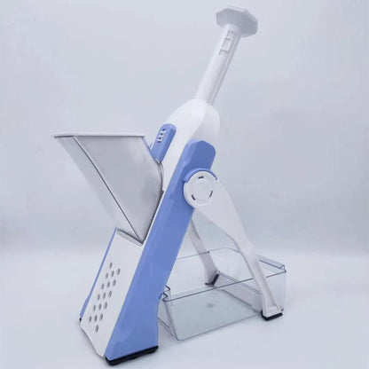 Orange multifunctional vegetable cutter kitchen tool with mandoline blades on a countertop.
