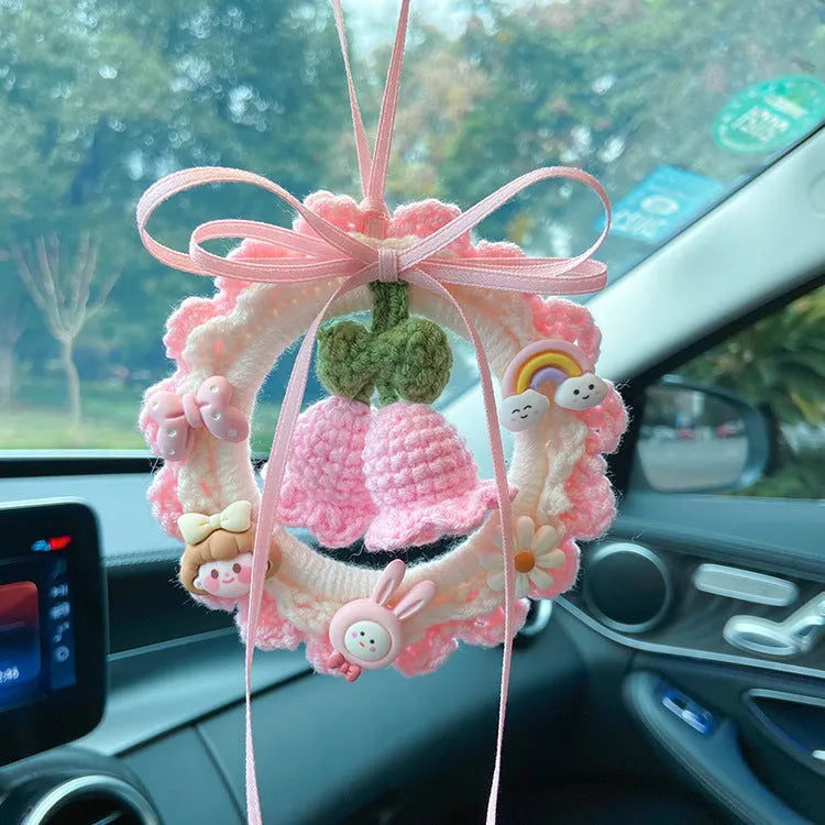 Green woven wool bell orchid car pendant hanging, showing handmade texture and fresh style.