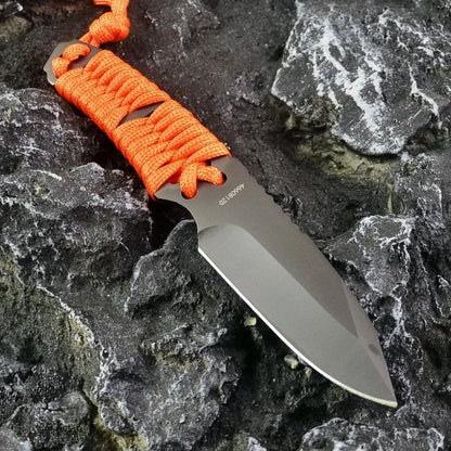 Straight-blade survival knife with a binding rope handle next to its black ABS plastic sheath.