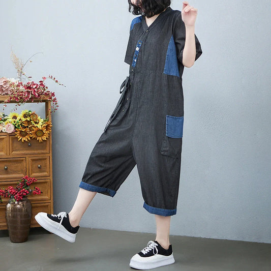Stylish women's denim drawstring jumpsuit in blue and black, featuring a custom fit waist and wide-leg cropped design.