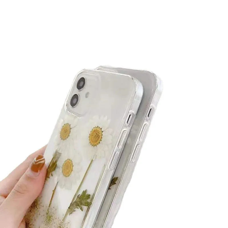 White iPhone case with a raised epoxy daisy flower pattern on the back.