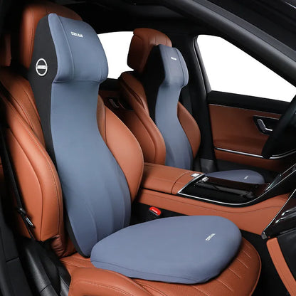 Black memory foam automotive waist cushion and matching headrest pillow set on a car seat.
