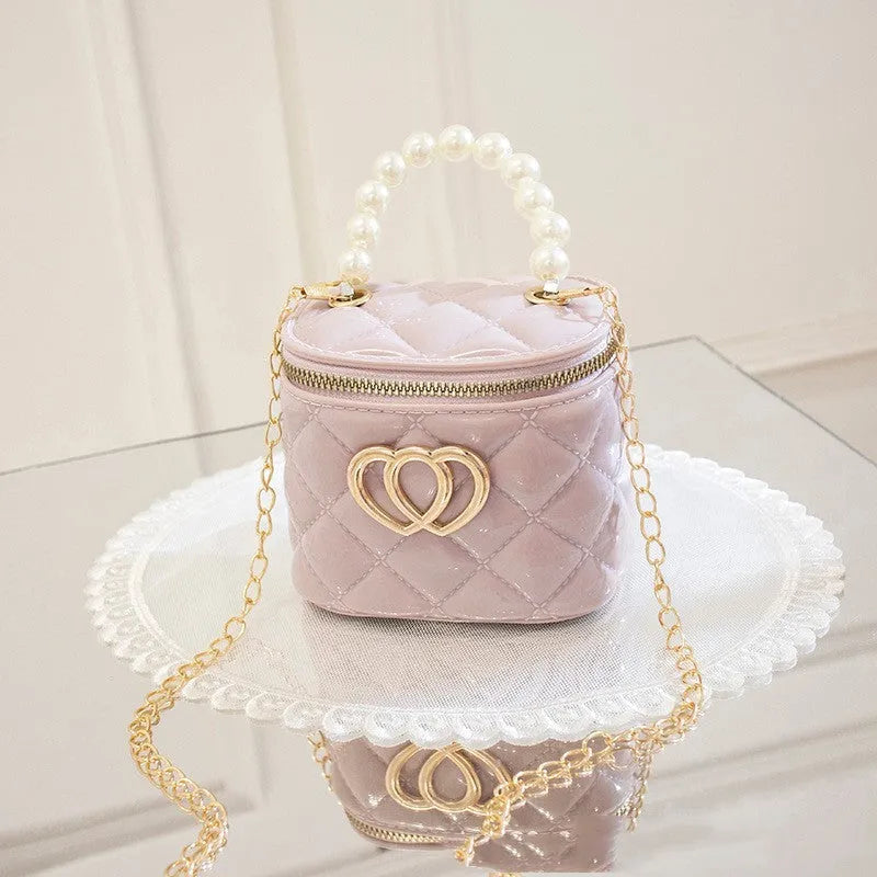 White PVC women's bucket bag with a heart-shaped pattern and shoulder strap.
