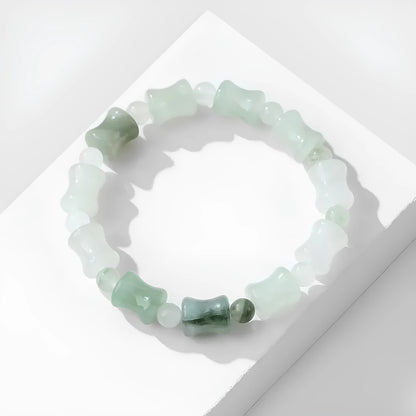 Simple Korean-style bracelet with natural chalcedony and coconut shell beads on an elastic string, showing the diamond-shaped safety lock.
