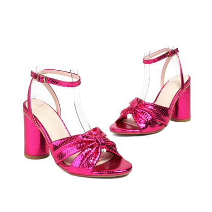 Gold plus size high heel peep toe sandal with an ankle strap buckle on a white background