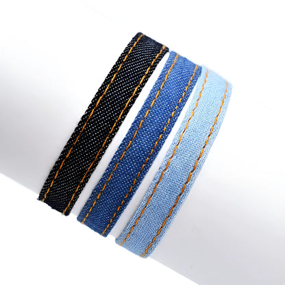 National style denim fabric bracelet carrying strap showing mixed material construction and wristband design