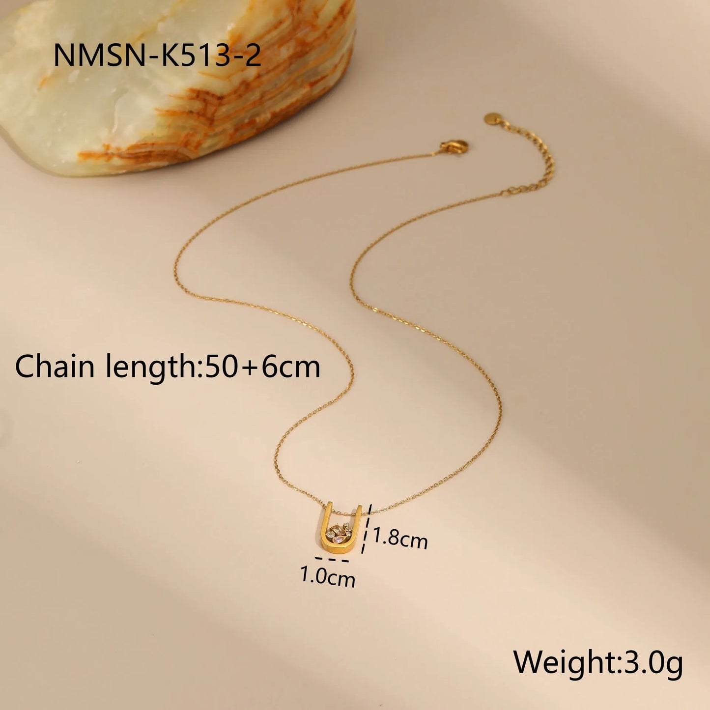 Gold geometric jewellery set with colour zircon accents showing necklace, ring, and earrings
