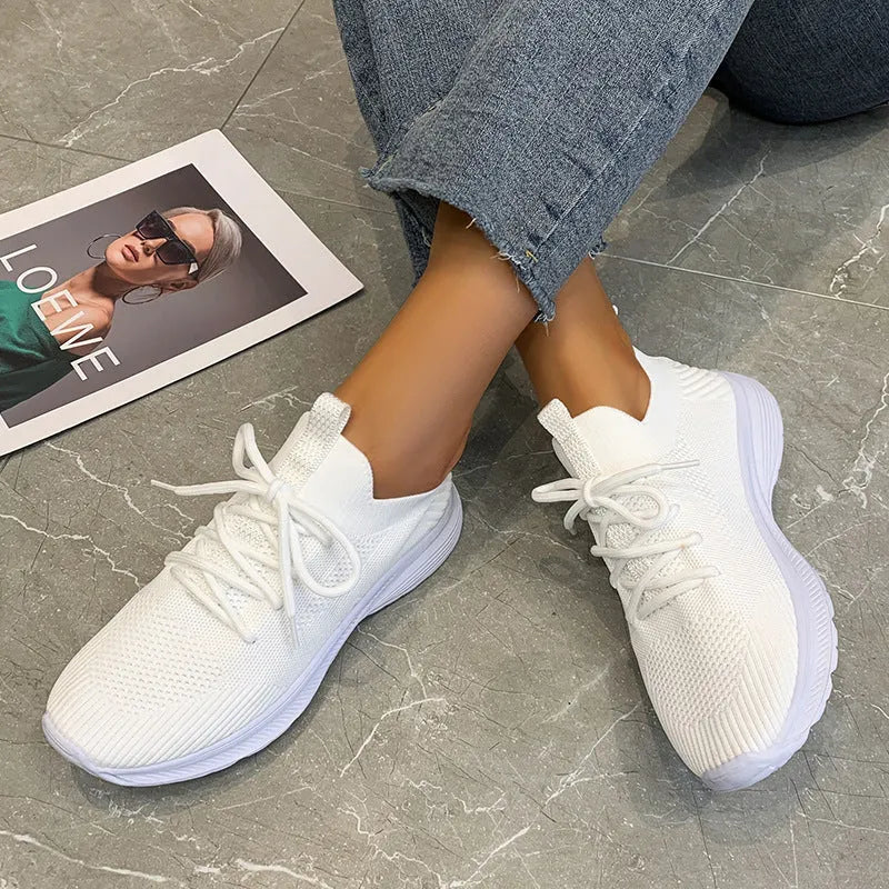 Women's Flyknit mesh running shoes in milky white with a low flat heel and rubber sole