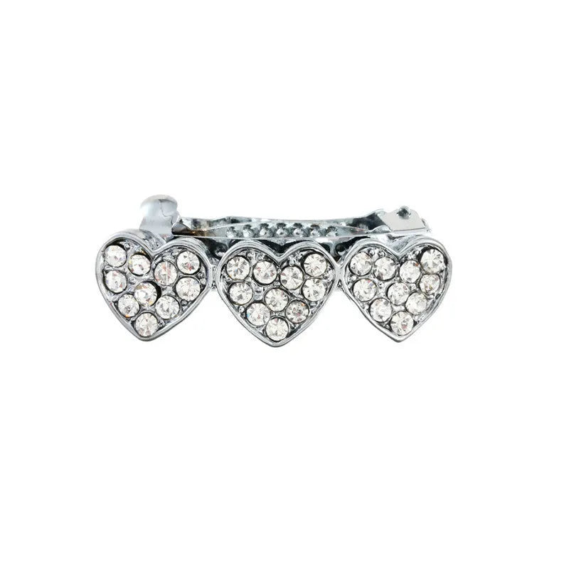 A 3cm long peach heart shaped hair clip with rhinestones and a small dog charm, on a white background.