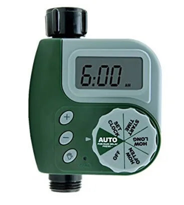 Green digital garden hose timer with large display shown connected to an outdoor tap.