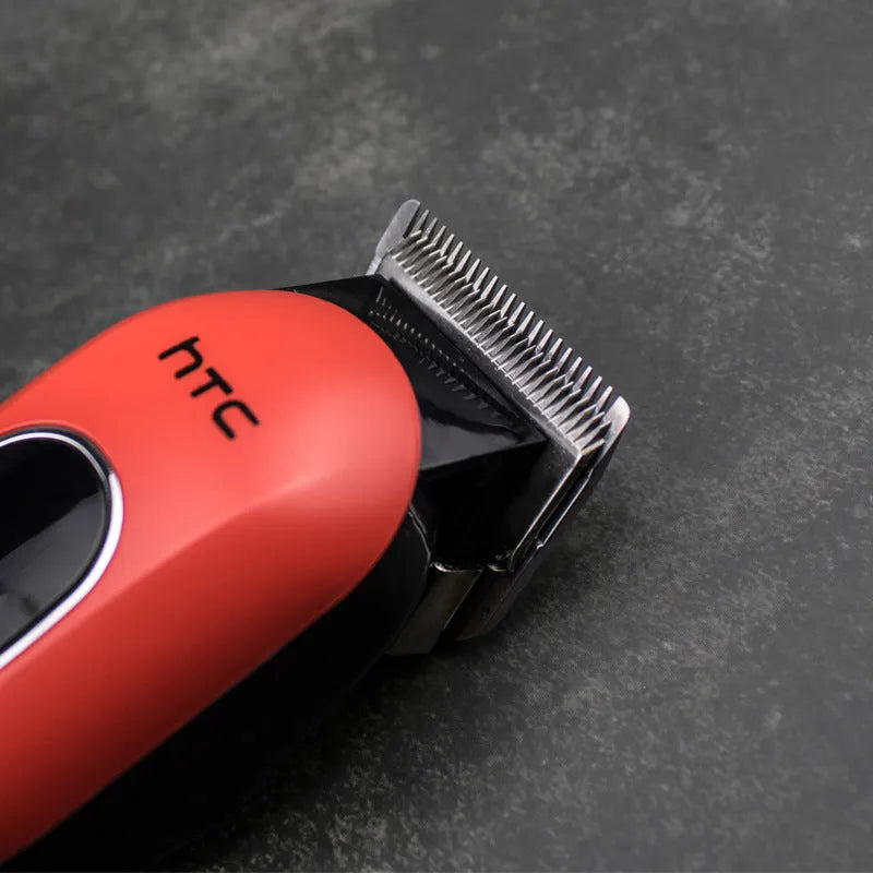 Professional digital electric hair clipper with brushless motor, charger, combs, and cleaning kit in black, red, and white colours.